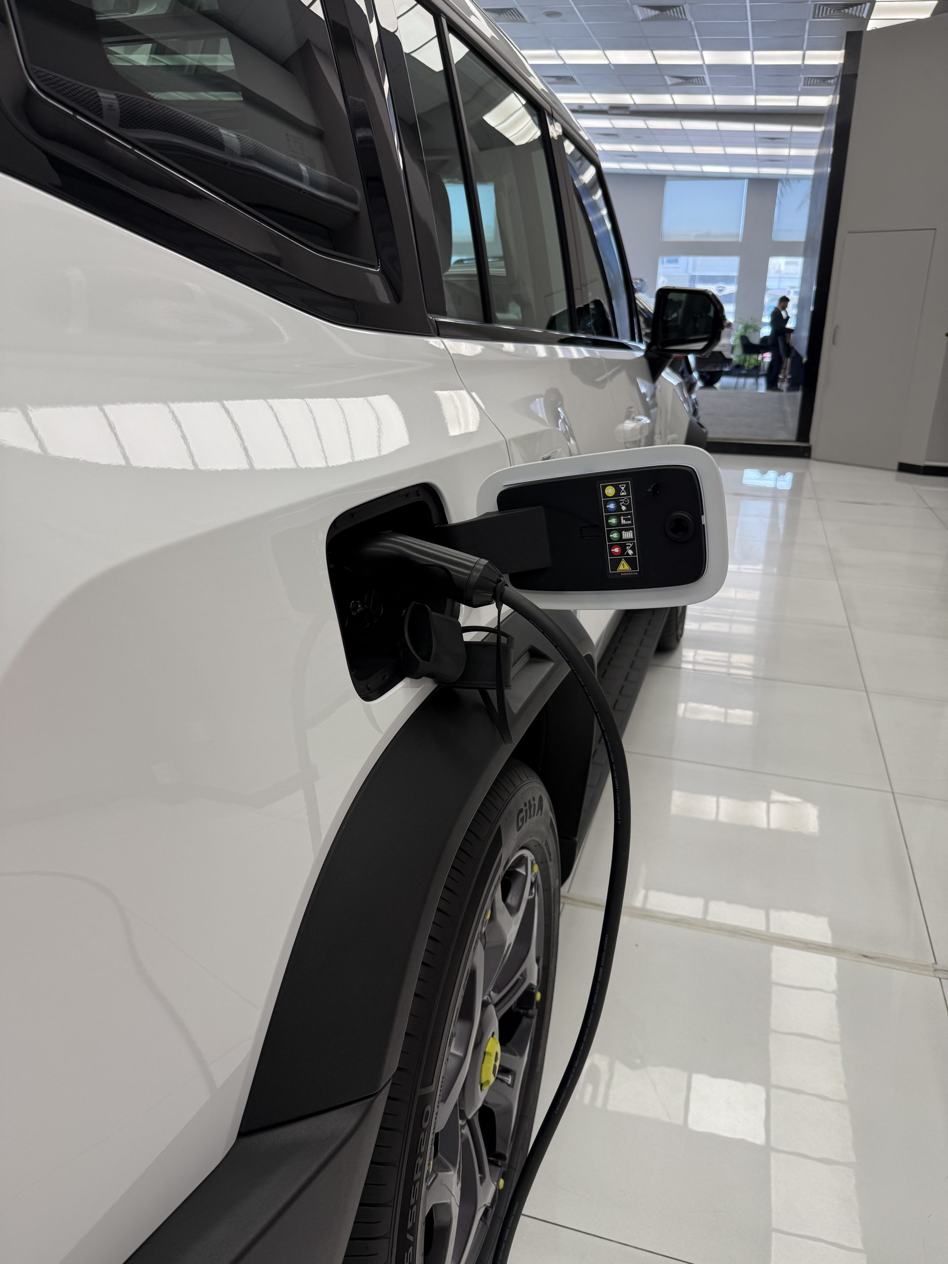Jetour T2i-DM plug-in hybrid SUV charging via external charger at Dubai showroom