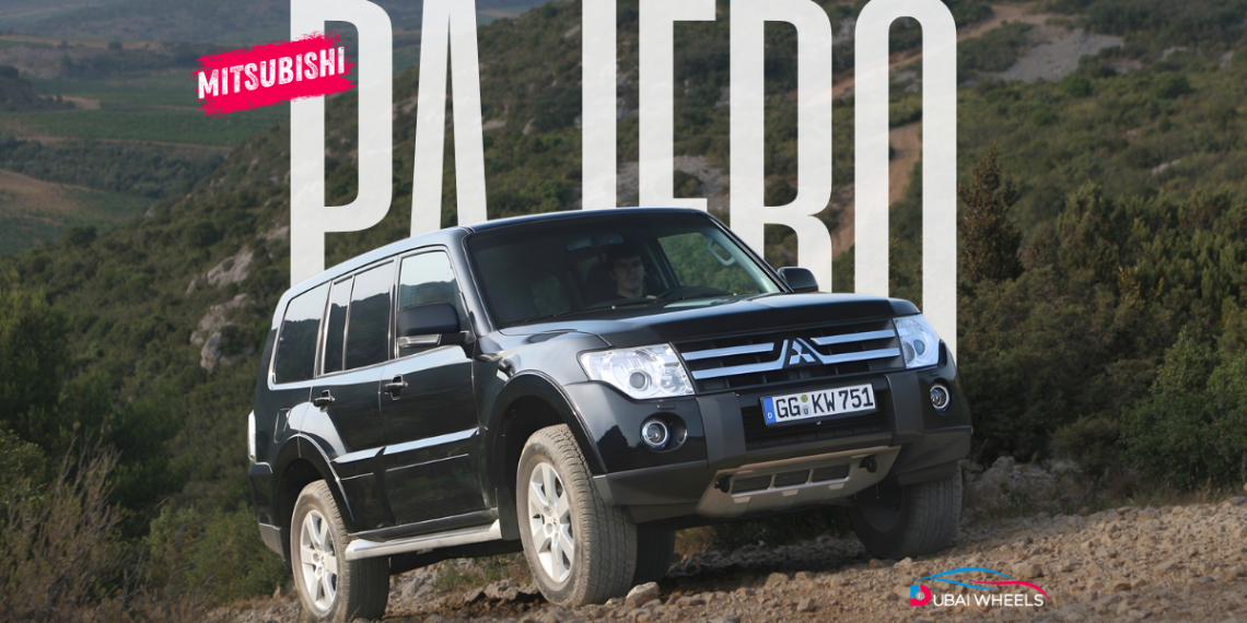 Mitsubishi Pajero driving across UAE desert dunes showcasing power, performance, and reliability among fuel efficient cars in UAE.