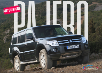 Mitsubishi Pajero driving across UAE desert dunes showcasing power, performance, and reliability among fuel efficient cars in UAE.