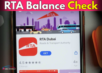 A commuter in Dubai checking RTA balance on mobile app and Nol card to stay updated on Salik and transport balance.