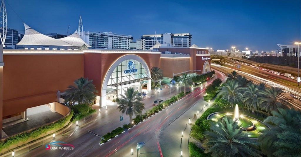 Deira City Centre Bus Station beside the metro and mall, showing bus platforms, commuter access, and connections to Old Dubai and major Dubai routes.