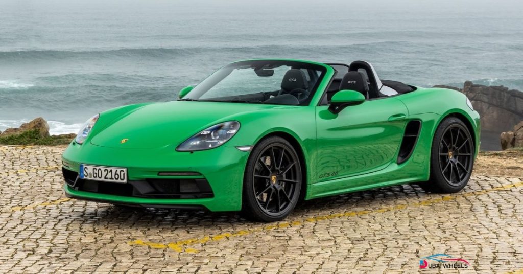 Porsche 718 Boxster convertible car driving along Dubai coastline UAE