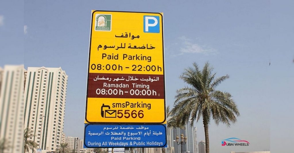 Current Sharjah parking timings 2025-2026 showing extended hours from 8 AM to midnight, blue and white curbs, and 7-day paid parking zones