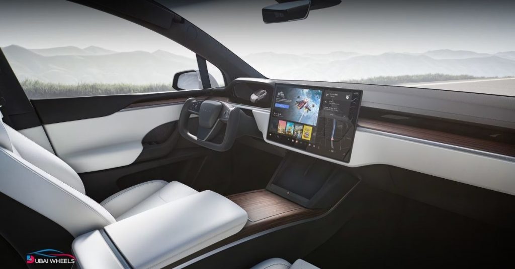 Interior of Tesla Model X in UAE showing comfort, technology, panoramic windshield, and touchscreen features