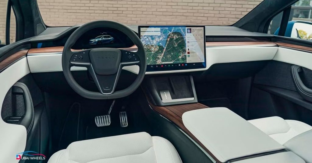 Tesla Model X interior UAE featuring futuristic cabin, panoramic windshield, large touchscreen, and 7-seater luxury electric SUV layout