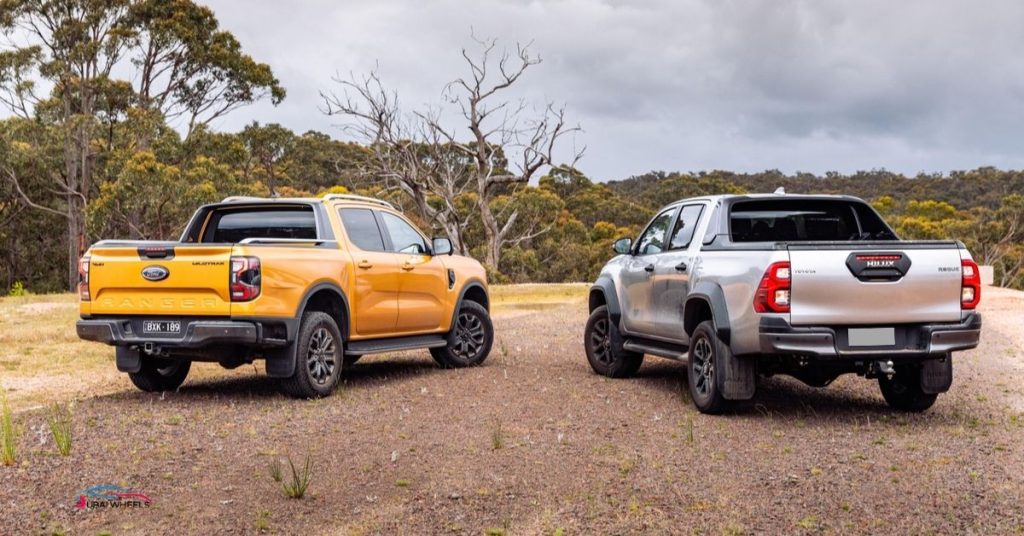 Ford Ranger Wildtrak 4X4 vs Toyota Hilux Invincible off-road performance comparison in UAE desert showing ground clearance and 4x4 capability