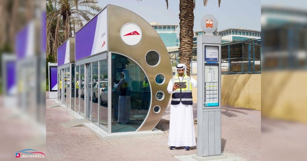 Commuters waiting inside air-conditioned RTA Bus Shelters Dubai with digital arrival display
